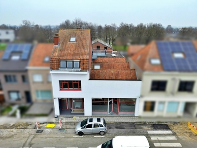 Polyvalent gebouw met appartement, magazijn en tuin