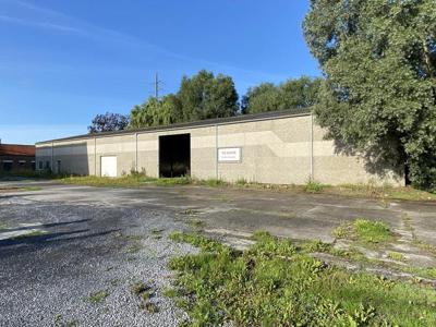 Loods van ca. 850 m² met voorliggende verharde koer/parking.